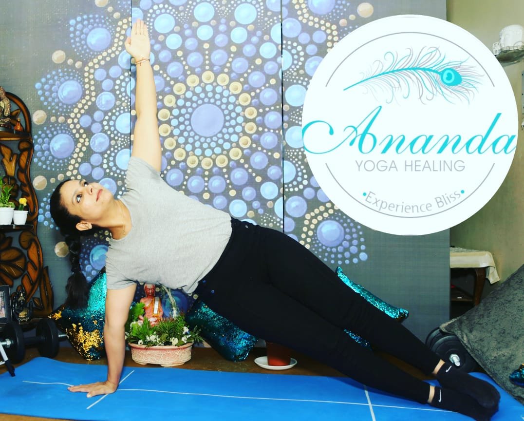 Dr. Nisha Sood in a side plank yoga pose